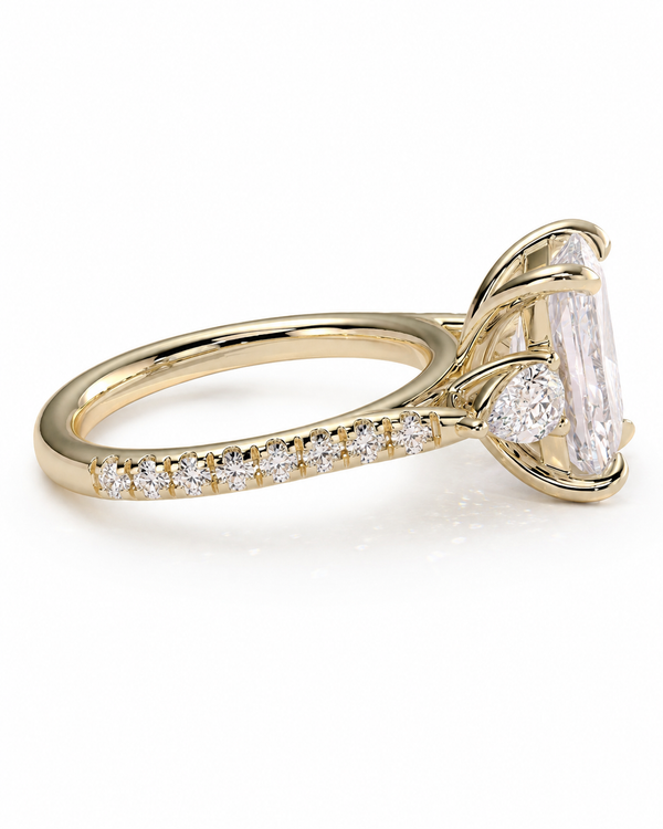 color_10K_YG, color_14K_YG &&A yellow gold engagement ring featuring a large rectangular emerald-cut center stone and a row of small round-cut stones along the band, set against a clean white background.