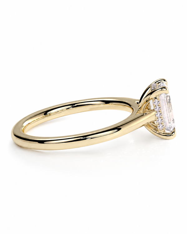 color_10K_YG, color_14K_YG &&A yellow gold ring featuring a large rectangular emerald-cut clear gemstone in a prong setting, accented by smaller round stones along the band, shown on a clean white background.