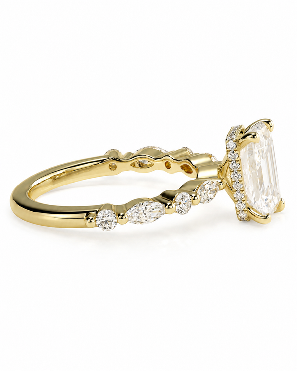 color_10K_YG, color_14K_YG &&A yellow gold ring featuring a large rectangular clear gemstone in a prong setting, accented by smaller marquise and round-cut clear stones along the band, shown on a plain white background.
