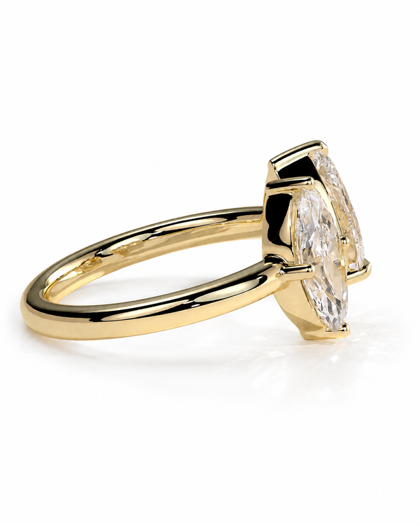 color_10K_YG, color_14K_YG &&A yellow gold ring featuring a marquise-cut clear gemstone in a four-prong setting, shown from a side angle on a clean white background.