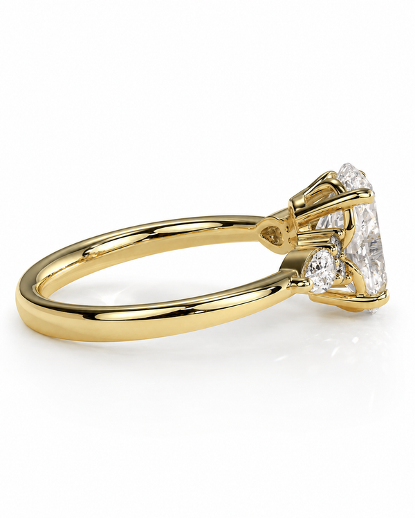 color_10K_YG, color_14K_YG &&A yellow gold diamond ring with a large round brilliant-cut center stone and smaller side stones, shown in a three-quarter side view on a white background.