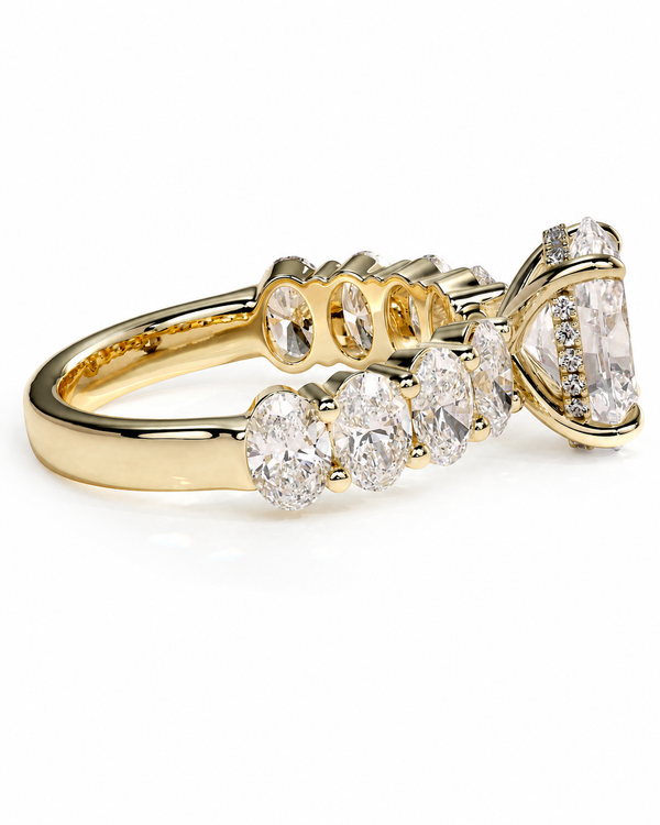color_10K_YG, color_14K_YG &&A yellow gold diamond ring with a marquise-cut center stone and a row of round and oval diamonds along the band, shown on a clean white background.