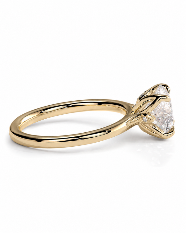 color_10K_YG, color_14K_YG &&A yellow gold diamond ring with a marquise-cut center stone and a small accent diamond on the band, shown on a clean white background.
