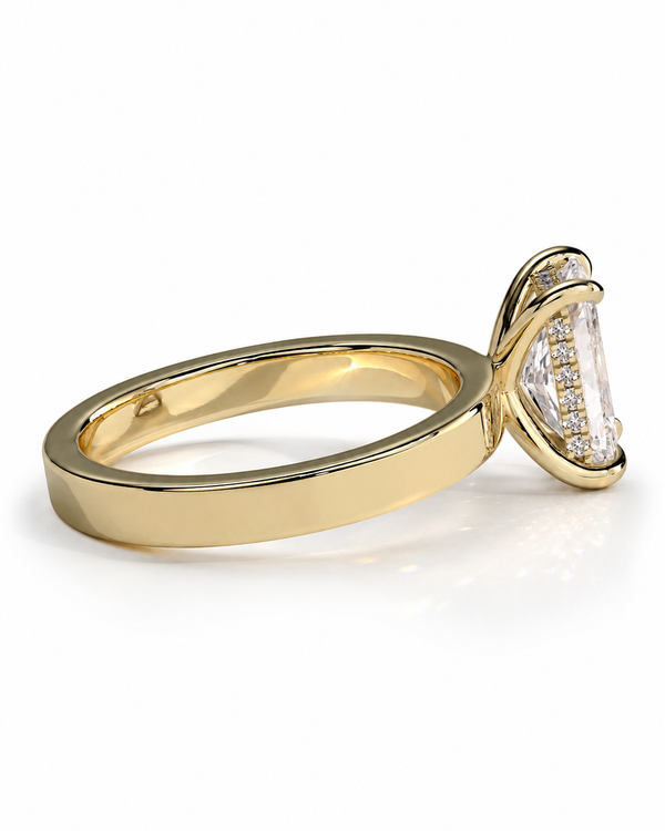 color_10K_YG, color_14K_YG &&A yellow gold ring featuring a large marquise-cut clear gemstone in a prong setting, accented by small pavé diamonds along the side of the stone, shown on a clean white background.