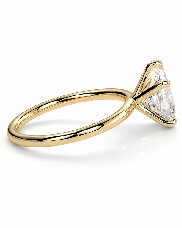 color_10K_YG, color_14K_YG &&
A yellow gold solitaire engagement ring featuring a triangular-cut clear gemstone in a prong setting, shown on a clean white background.