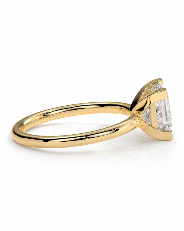 color_10K_YG, color_14K_YG &&A yellow gold ring with a triangular bezel setting holding a large clear baguette-cut center stone and smaller side stones, shown on a clean white background.