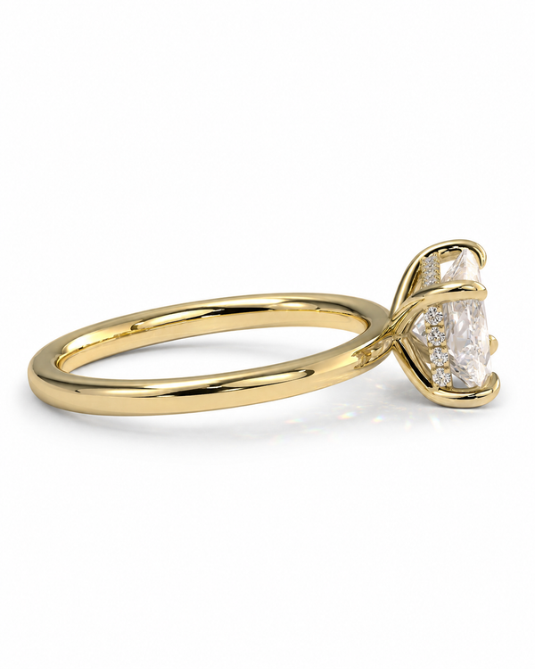 color_10K_YG, color_14K_YG &&A yellow gold ring with a curved, twisted band and a clear rectangular gemstone in a prong setting, shown on a plain white background.