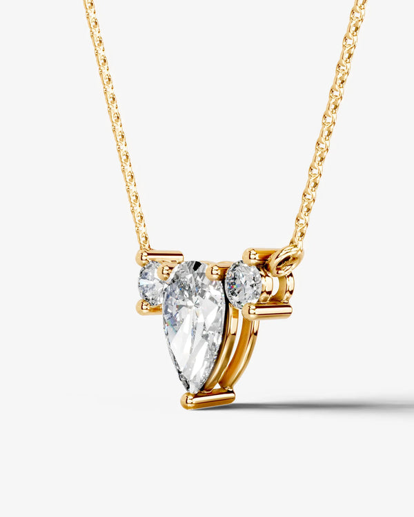 Close-up of a pear Moissanite cluster pendant highlighting the secure prong setting and brilliant round side stones.