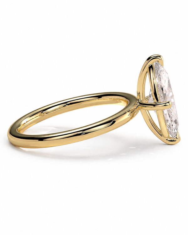 color_10K_YG, color_14K_YG &&A yellow gold ring featuring a large, clear marquise-cut gemstone in a prong setting, shown from a side profile view on a clean white background.