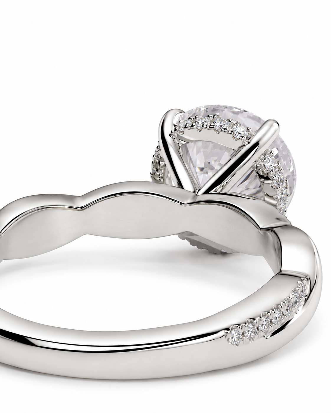 color_925_SIL,color_935_ARG,color_10K_WG, color_14K_WG &&
A close-up studio shot of a silver-toned ring featuring a large round clear gemstone in a prong setting, surrounded by a halo of smaller stones, with a polished band accented by small pave stones.