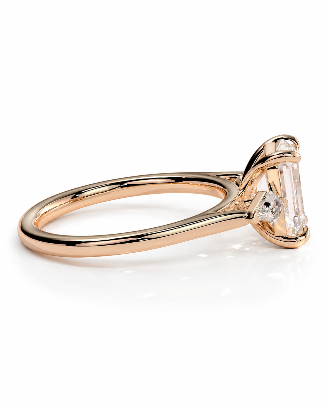 color_10K_RG, color_14K_RG &&
A rose gold engagement ring featuring a large emerald-cut clear center stone and a smaller round side stone, shown on a clean white background.