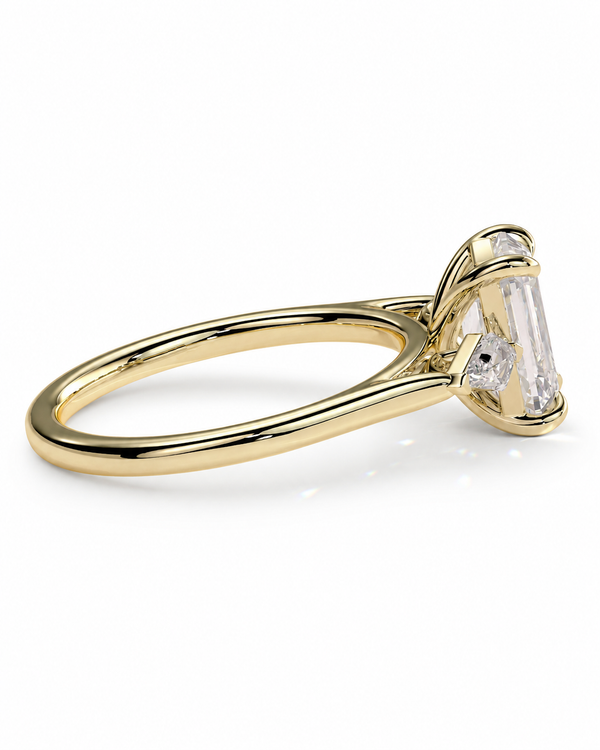 color_10K_YG, color_14K_YG &&
A yellow gold ring with a large emerald-cut clear center stone and smaller side stones, shown on a clean white background.