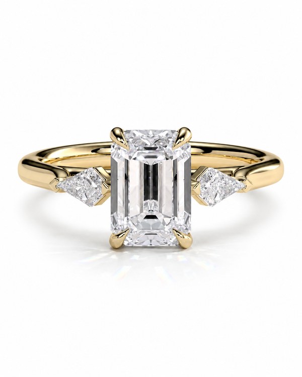 color_10K_YG, color_14K_YG &&
A yellow gold engagement ring featuring a large emerald-cut diamond center stone and two smaller round-cut diamonds on the shoulders, set against a clean white background.