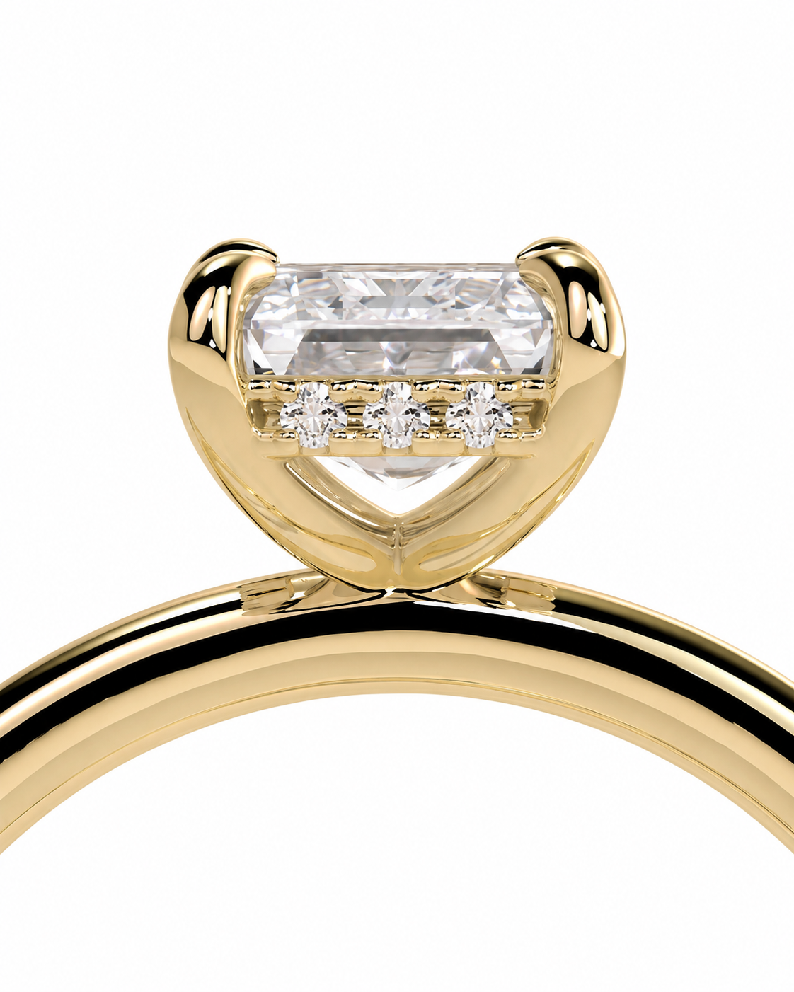 color_10K_YG, color_14K_YG &&
A close-up of a yellow gold ring featuring a heart-shaped bezel setting with a large rectangular clear gemstone and three smaller round stones along the front, set against a plain white background.