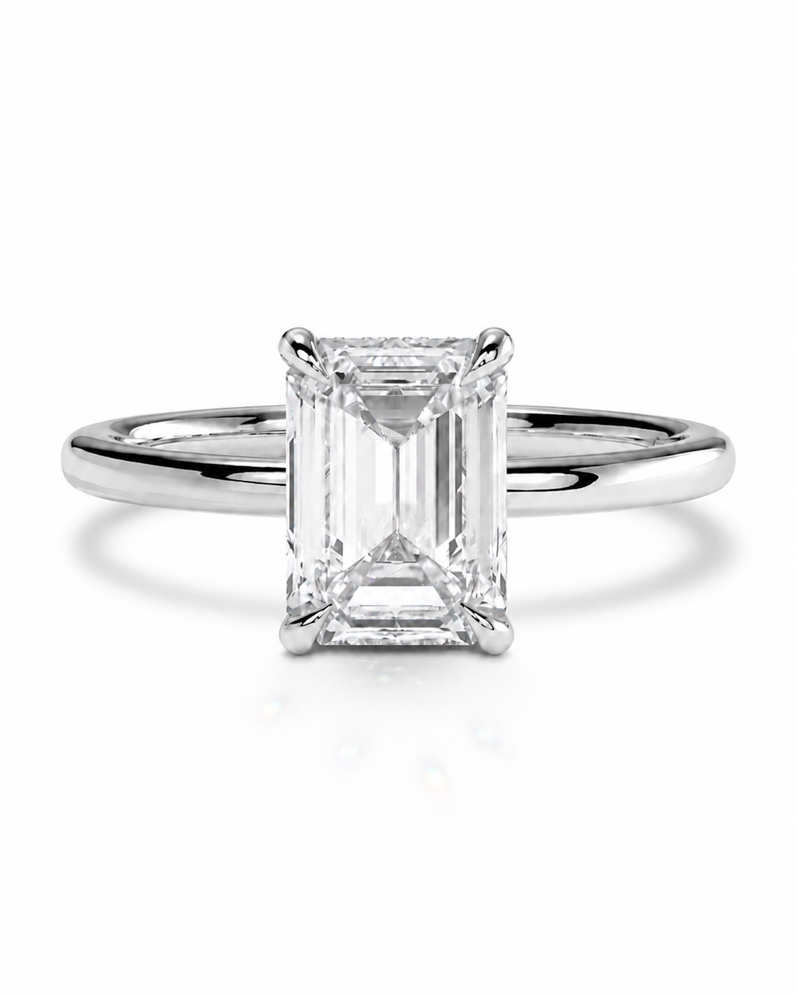 color_925_SIL,color_935_ARG,color_10K_WG, color_14K_WG &&
An emerald-cut diamond solitaire engagement ring in a polished silver-colored metal band, centered on a clean white background with a soft reflection.