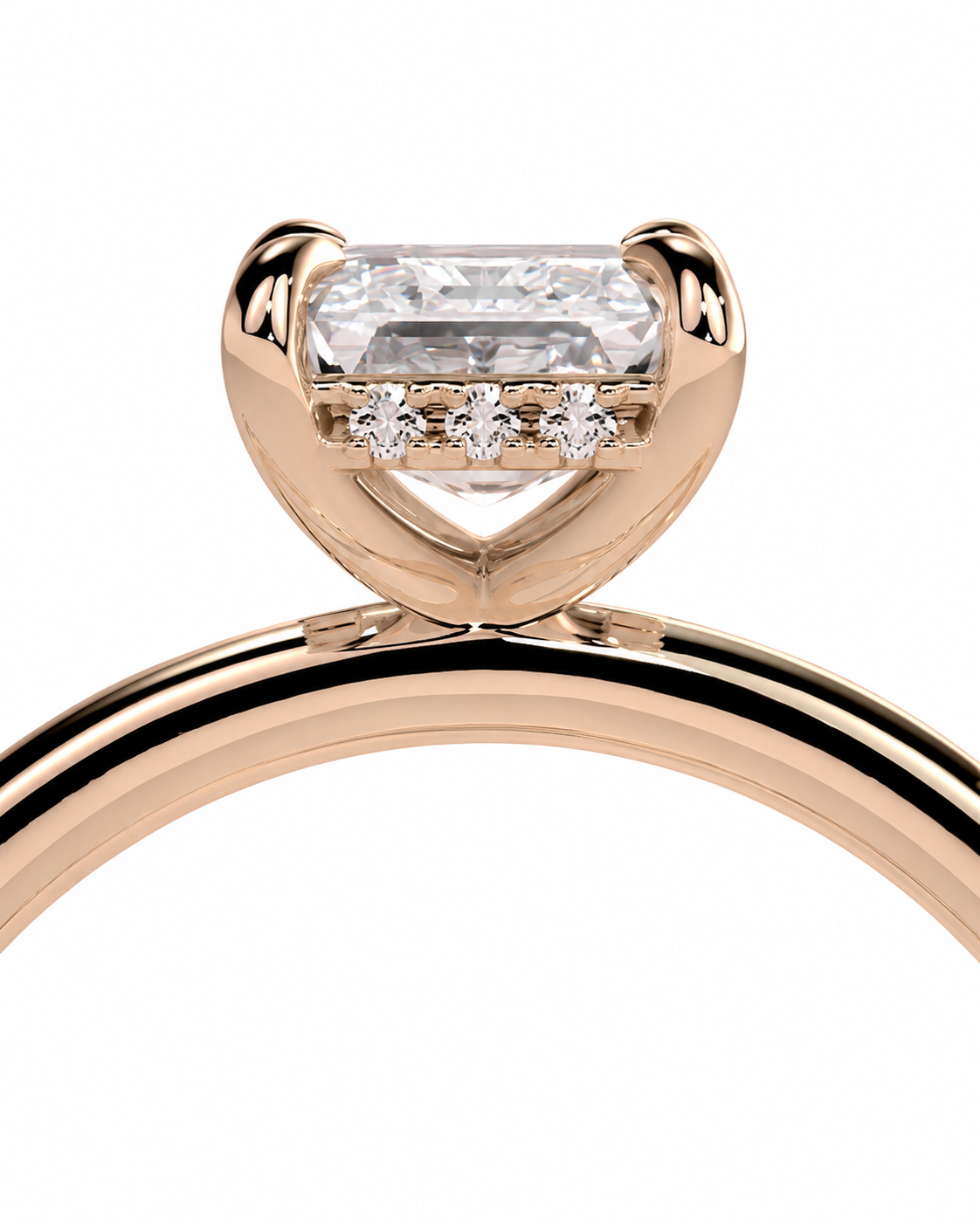 color_10K_RG, color_14K_RG &&
Rose gold solitaire engagement ring featuring a large rectangular baguette-cut clear center stone and three small round stones in a row beneath the setting, shown on a plain white background.