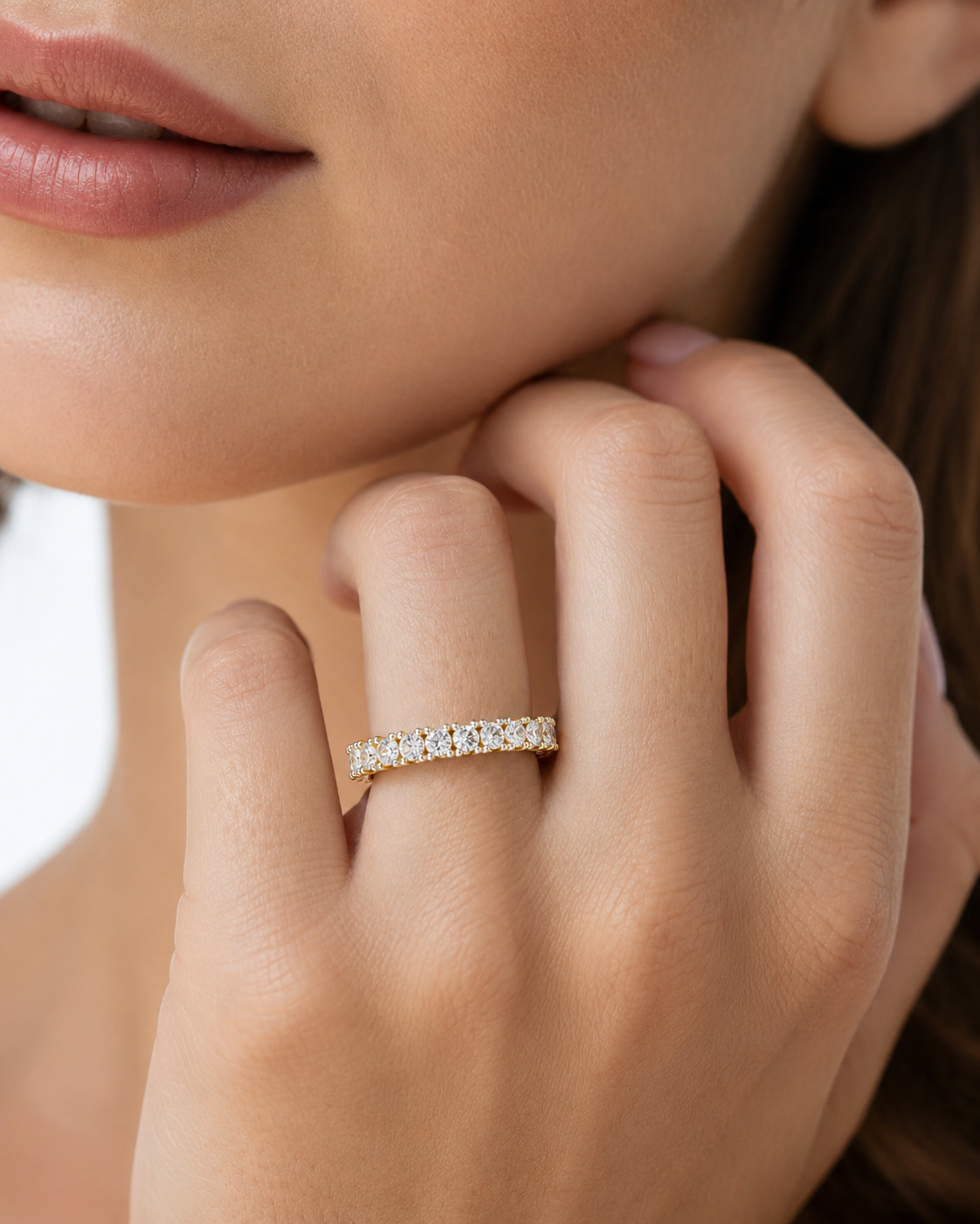 color_10K_YG, color_14K_YG &&Close-up of a full eternity wedding band showcasing round moissanite stones and shared prongs.