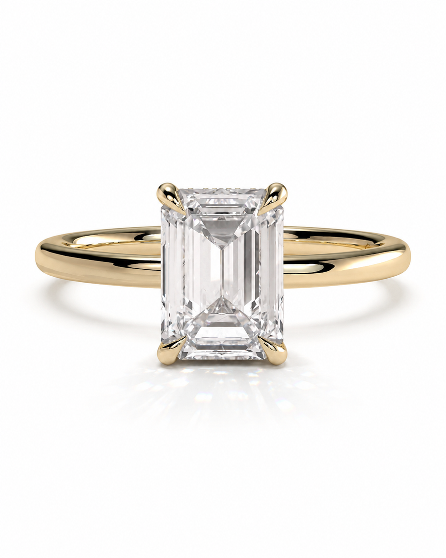 color_10K_YG, color_14K_YG &&
An emerald-cut diamond engagement ring with a yellow gold band, shown on a clean white background with a soft reflection.