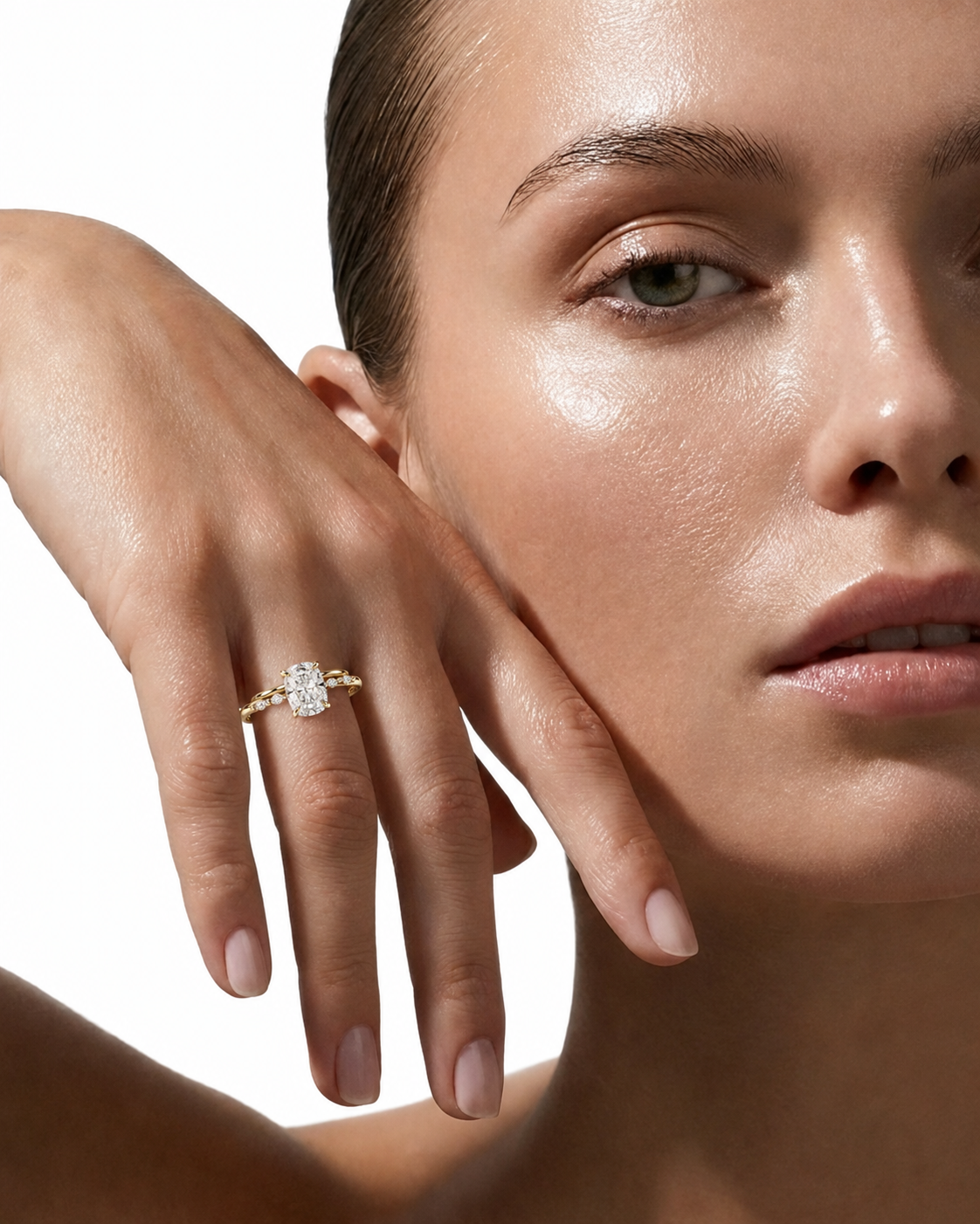 color_10K_YG, color_14K_YG &&
A close-up lifestyle shot of a model wearing a yellow gold ring with a large round-cut clear gemstone on her finger, set against a clean white background.