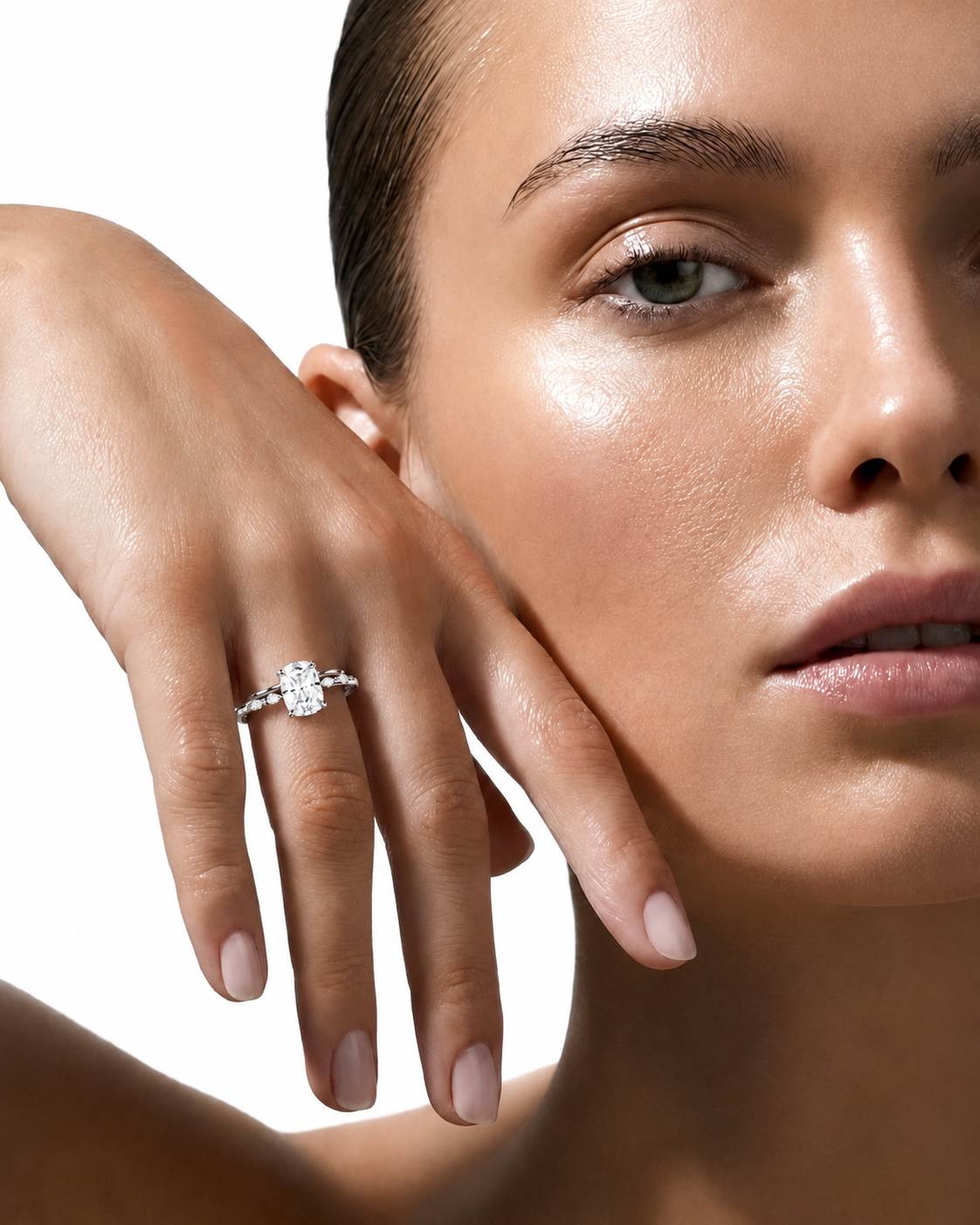 color_925_SIL,color_935_ARG,color_10K_WG, color_14K_WG &&
A close-up lifestyle shot of a model wearing a silver engagement ring with a round-cut clear gemstone on her finger, set against a clean white background.