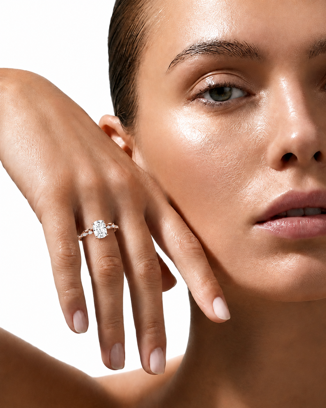 color_10K_RG, color_14K_RG &&
A close-up lifestyle shot of a model wearing a silver-toned diamond engagement ring on her finger, with her hand resting against her cheek against a clean white background.