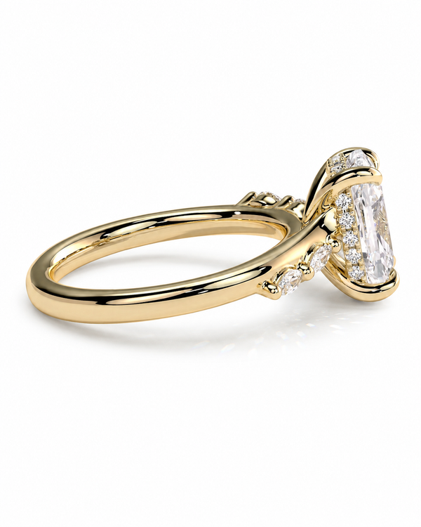 color_10K_YG, color_14K_YG &&
A yellow gold engagement ring featuring a large emerald-cut center stone and smaller round stones along the shoulders, set against a clean white background.