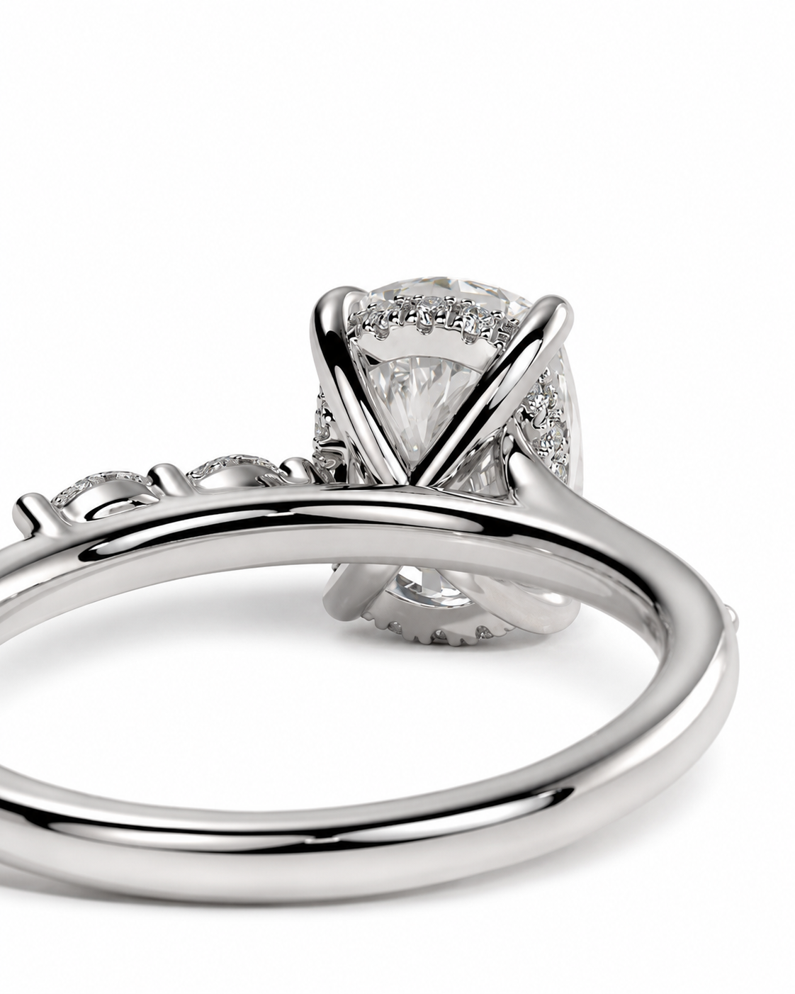 color_925_SIL,color_935_ARG,color_10K_WG, color_14K_WG &&
A close-up studio shot of a silver-toned ring featuring a large oval clear gemstone in a prong setting, surrounded by a halo of smaller stones, with a polished band visible in the foreground on a white background.