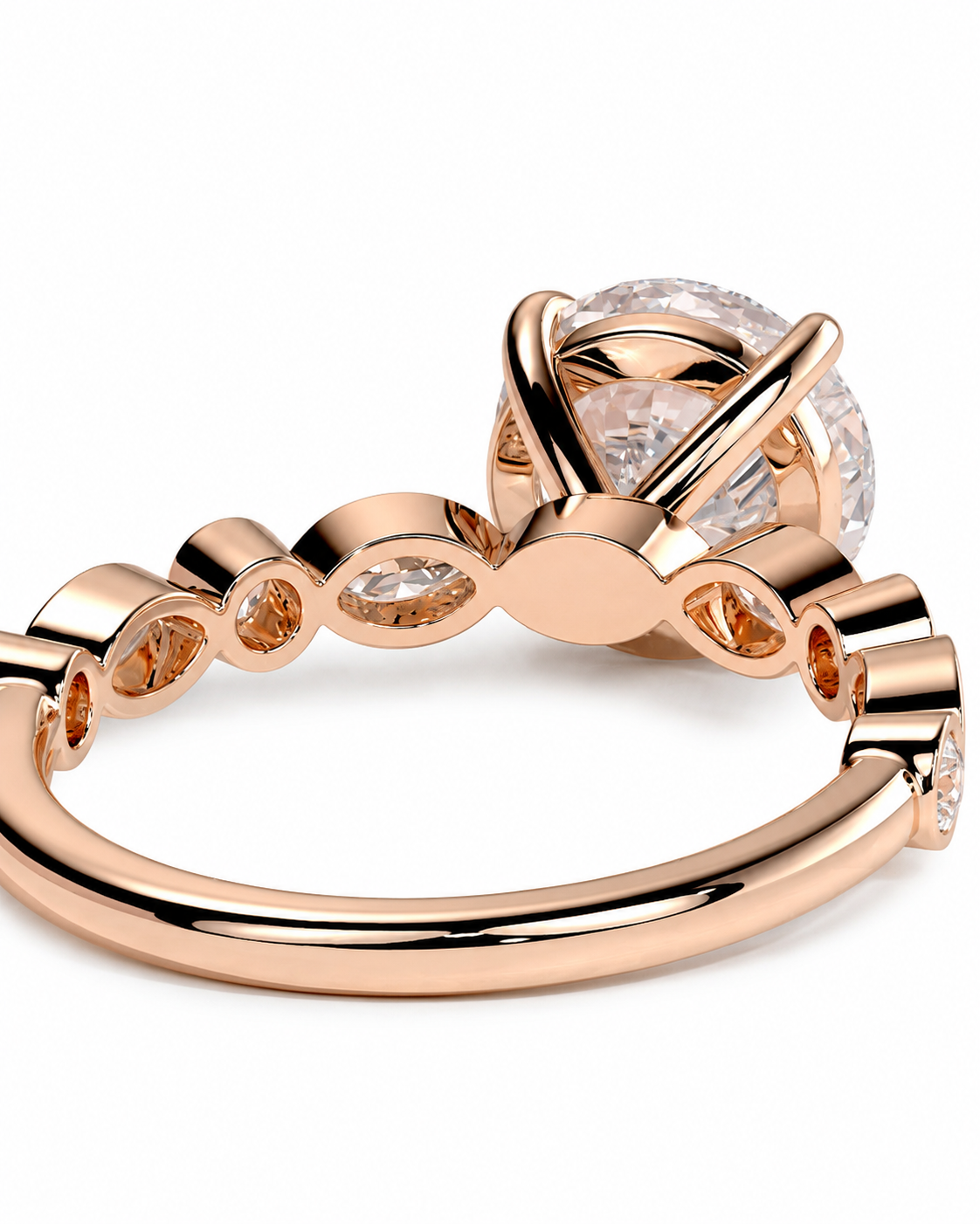 color_10K_RG, color_14K_RG &&
Rose gold ring with a large round clear gemstone in a wrap-style setting and smaller round stones along the band, shown on a white background.