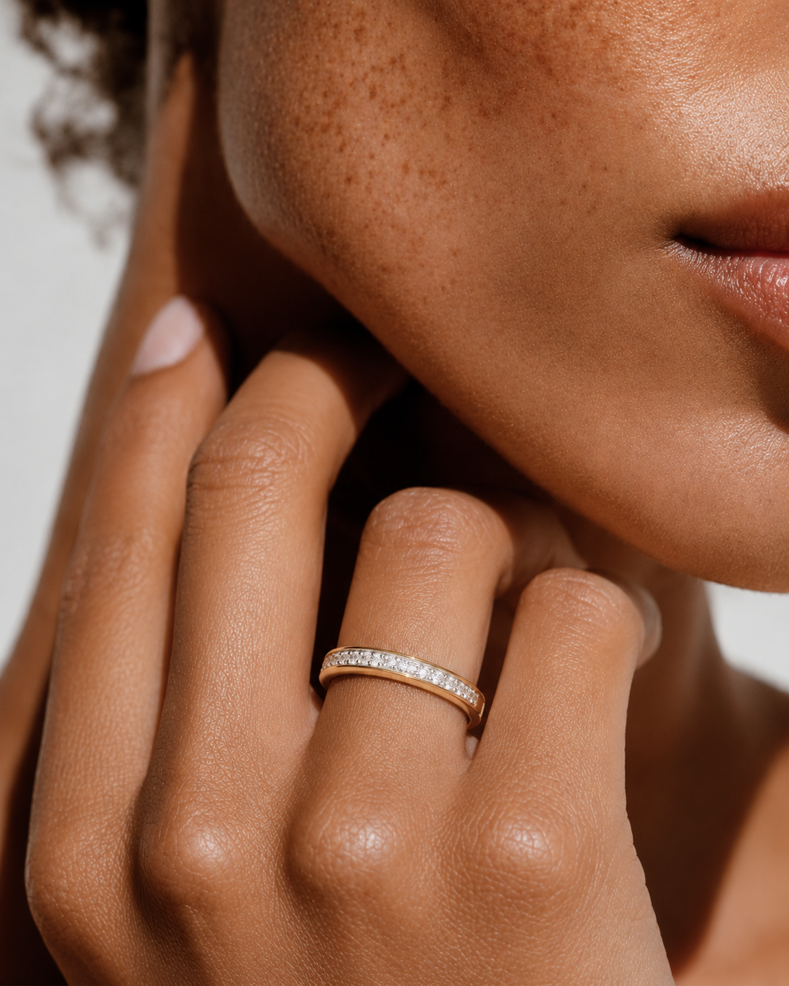 color_10K_YG, color_14K_YG &&Front view of a channel-set moissanite wedding band with polished finish