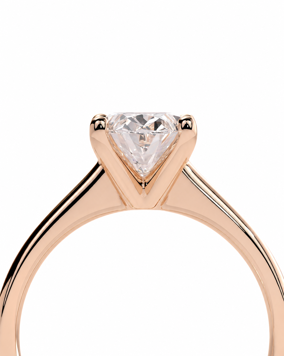 color_10K_RG, color_14K_RG &&A close-up of a rose gold solitaire engagement ring featuring a triangular-cut clear gemstone in a prong setting, shown against a plain white background.