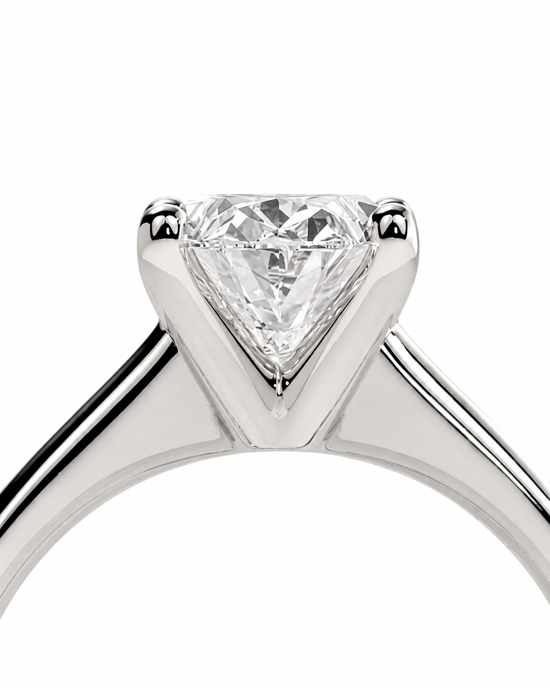 color_925_SIL,color_935_ARG,color_10K_WG, color_14K_WG &&A close-up studio shot of a silver-toned solitaire ring featuring a heart-shaped clear gemstone in a prong setting, shown against a plain white background.