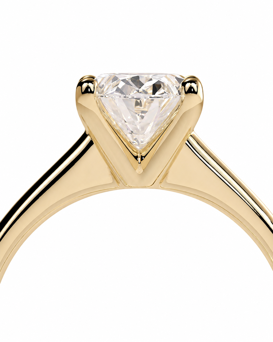 color_10K_YG, color_14K_YG &&A close-up of a yellow gold solitaire engagement ring featuring a triangular-cut clear gemstone in a prong setting, shown against a plain white background.