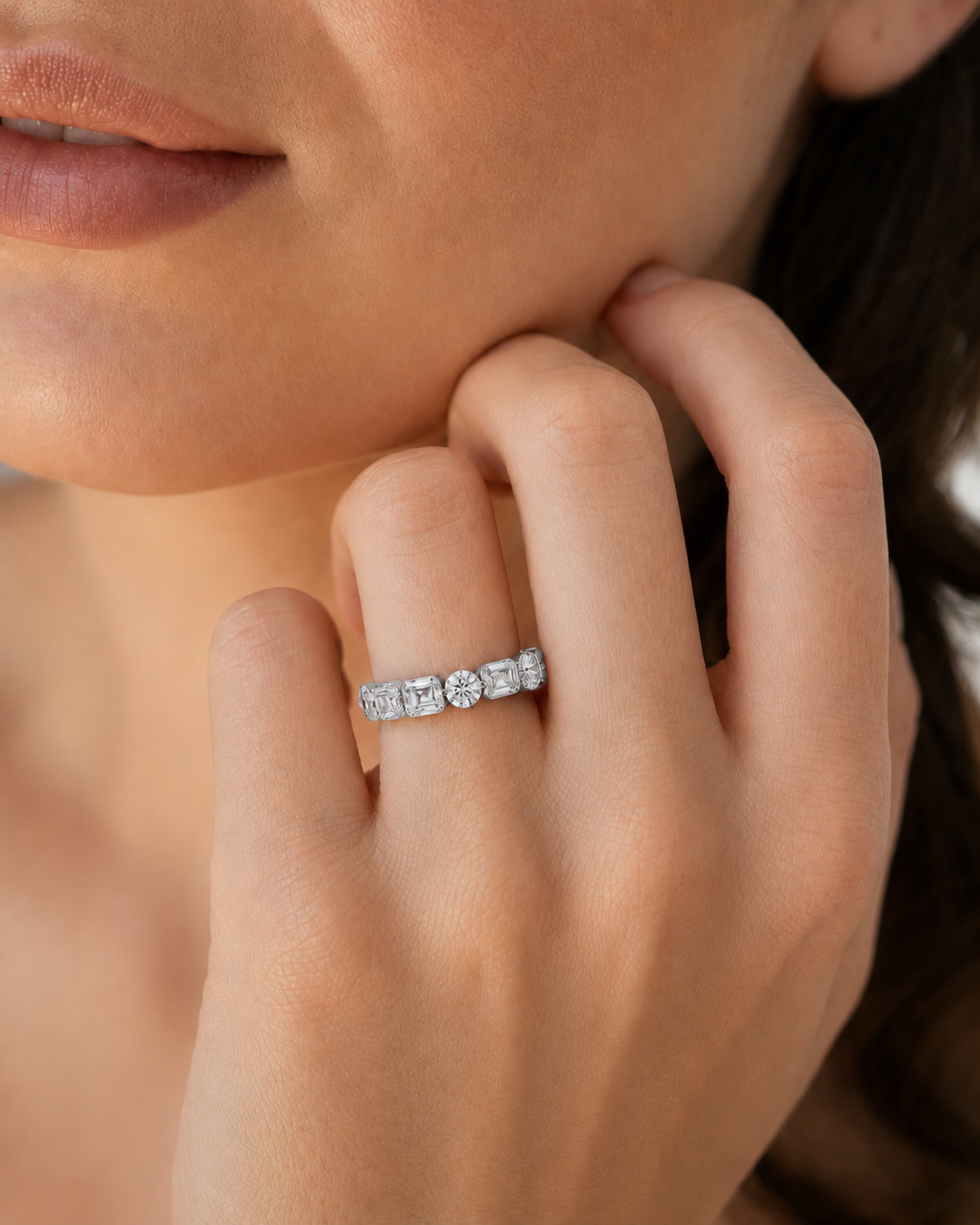 color_925_SIL,color_935_ARG,color_10K_WG, color_14K_WG &&	
A close-up of a woman's hand wearing a silver band ring with a row of sparkling square-cut and round diamonds.