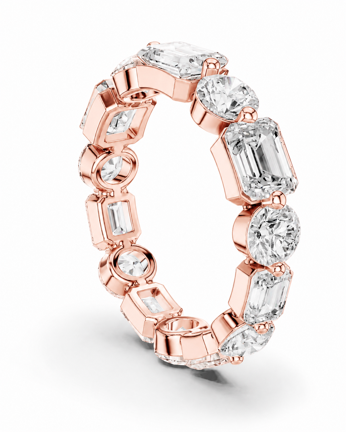 color_10K_RG, color_14K_RG &&	A rose gold eternity ring featuring a continuous line of clear gemstones in round, rectangular, and cushion cuts, set against a clean white background.