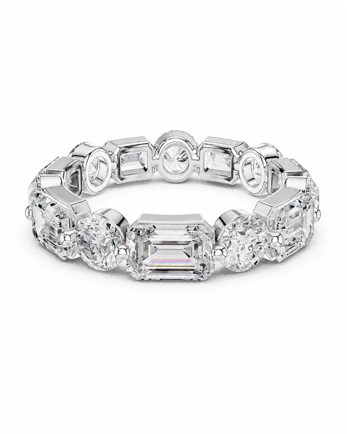 color_925_SIL,color_935_ARG,color_10K_WG, color_14K_WG &&	
A silver-toned eternity ring featuring a central emerald-cut clear gemstone surrounded by round and baguette-cut clear gemstones, shown on a plain white background.