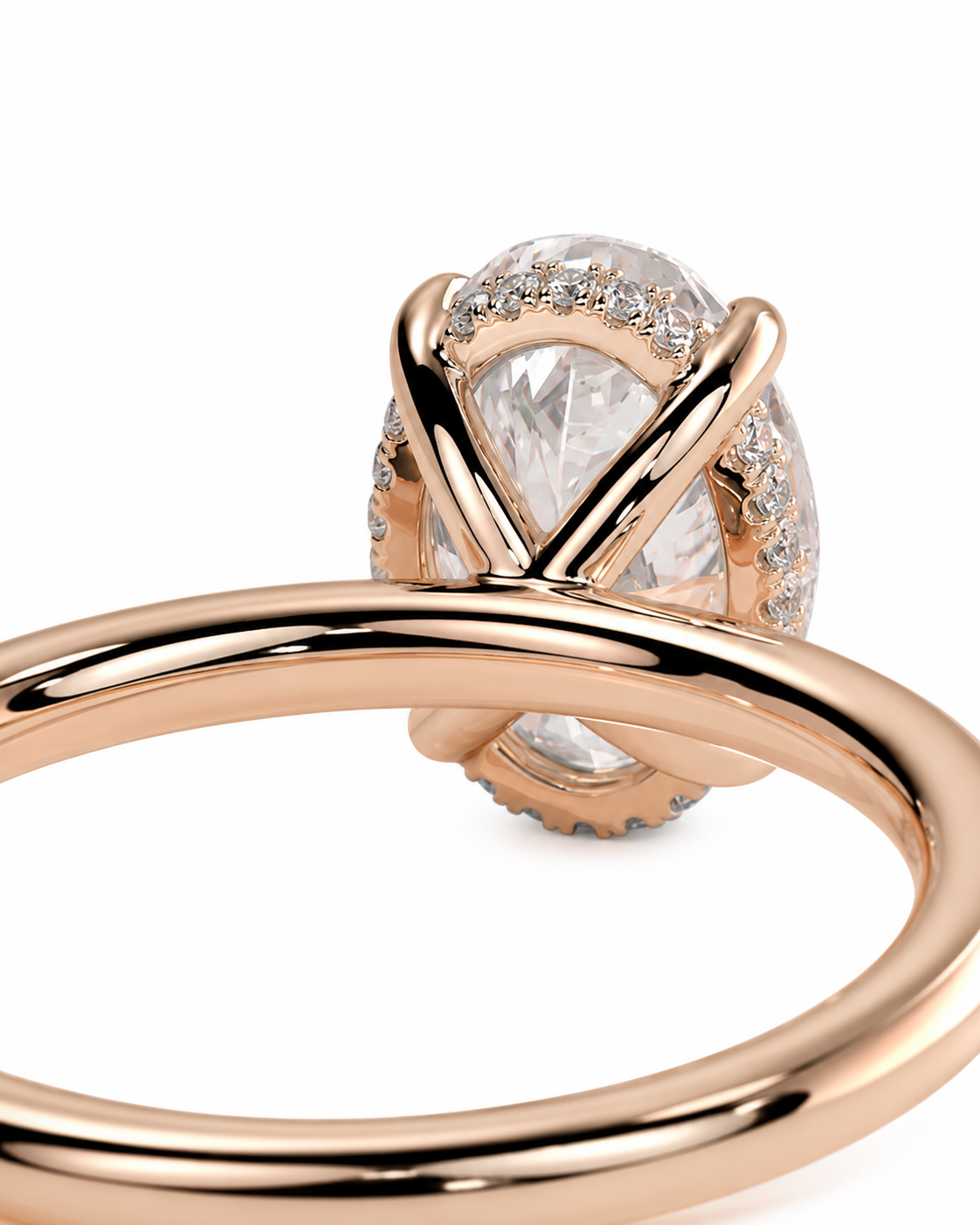 color_10K_RG, color_14K_RG &&Rose gold ring with a large pear-cut clear center stone and small accent stones, shown close up on a white background.