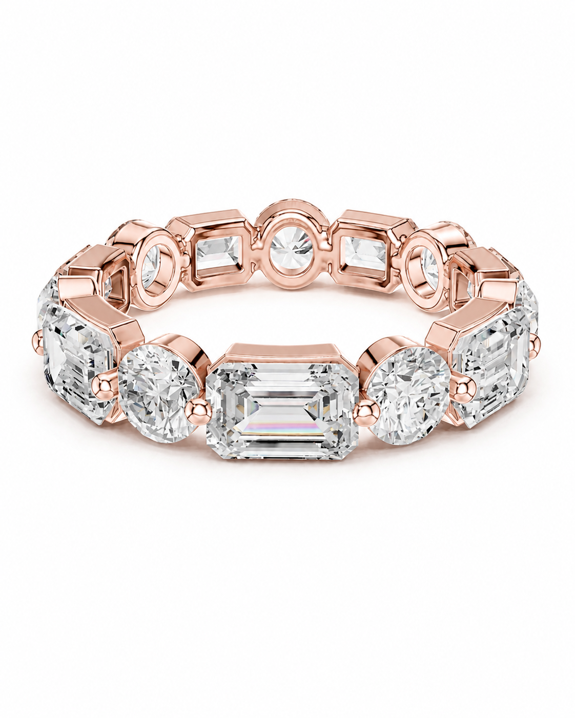 color_10K_RG, color_14K_RG &&	A rose gold eternity ring featuring a series of clear gemstones in oval, round, and emerald cuts, set against a clean white background.