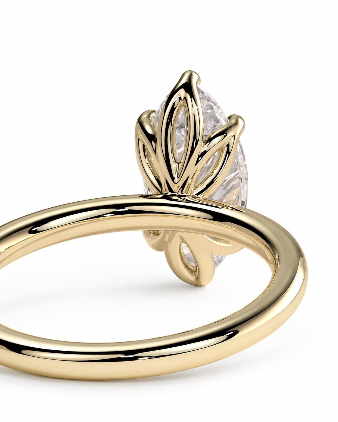 color_10K_YG, color_14K_YG &&A close-up shot of a yellow gold ring featuring a marquise-cut clear gemstone in a leaf-like crown setting, shown against a plain white background.