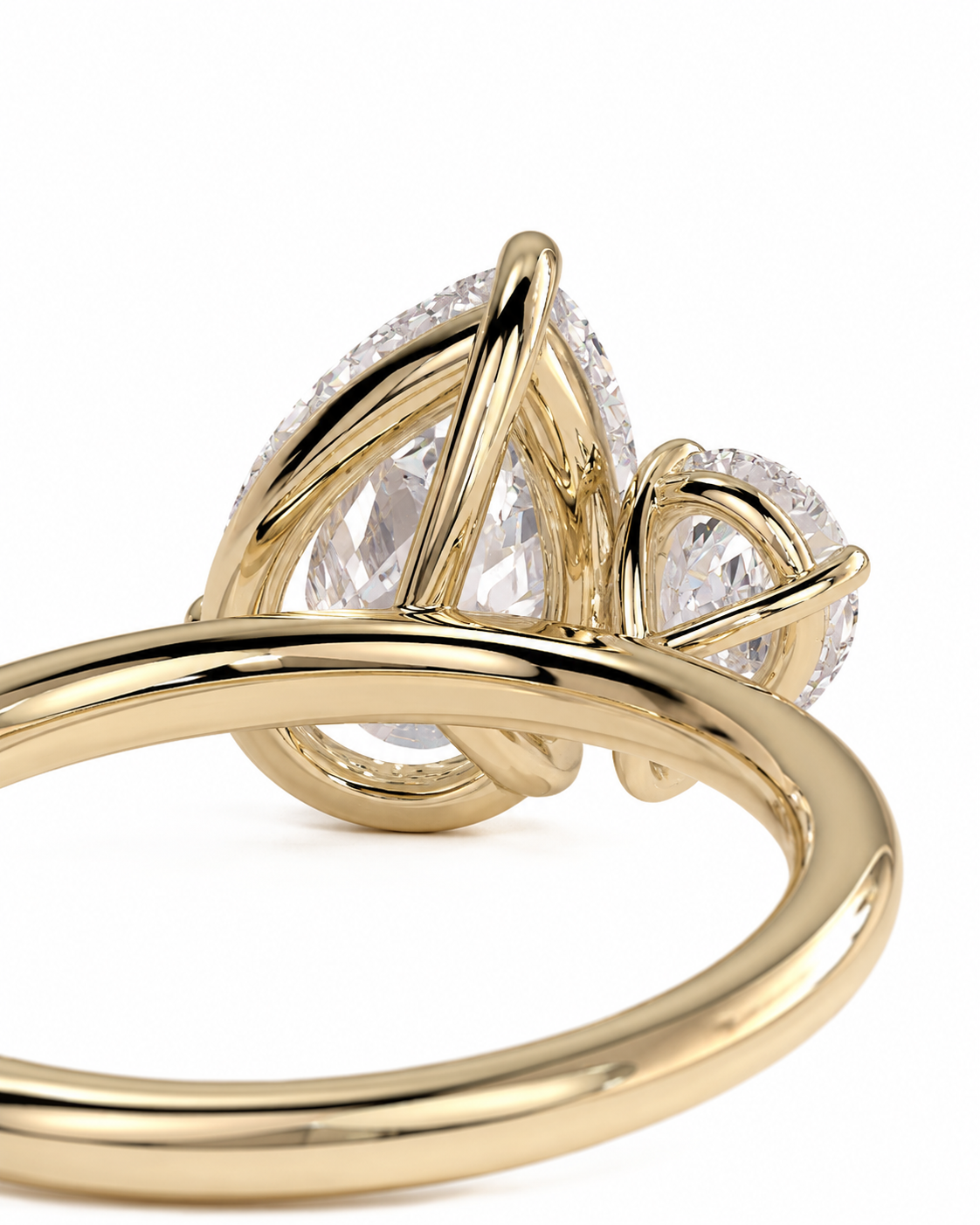 color_10K_YG, color_14K_YG &&A close-up of a yellow gold ring featuring a teardrop-shaped clear gemstone surrounded by small pave-set clear stones, with a polished wrap-around band, on a white background.