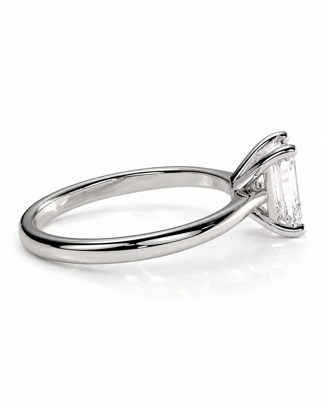 color_925_SIL,color_935_ARG,color_10K_WG, color_14K_WG &&A silver-toned solitaire engagement ring featuring a rectangular emerald-cut clear gemstone in a four-prong setting, shown on a clean white background.