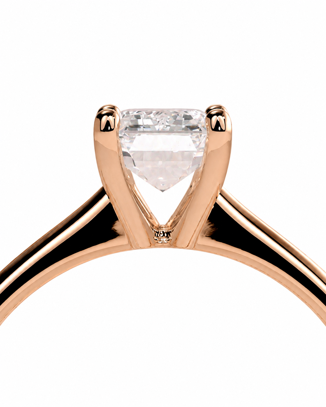 color_10K_RG, color_14K_RG &&A close-up of a rose gold solitaire engagement ring featuring a heart-shaped clear gemstone in a four-prong setting, shown against a solid white background.