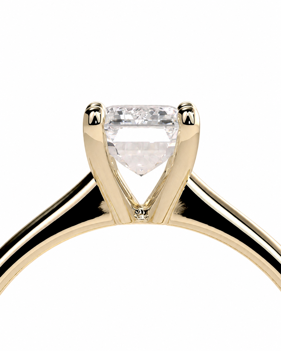 color_10K_YG, color_14K_YG &&A close-up of a solitaire engagement ring featuring a clear rectangular-cut diamond set in a polished yellow gold prong setting, shown against a solid white background.