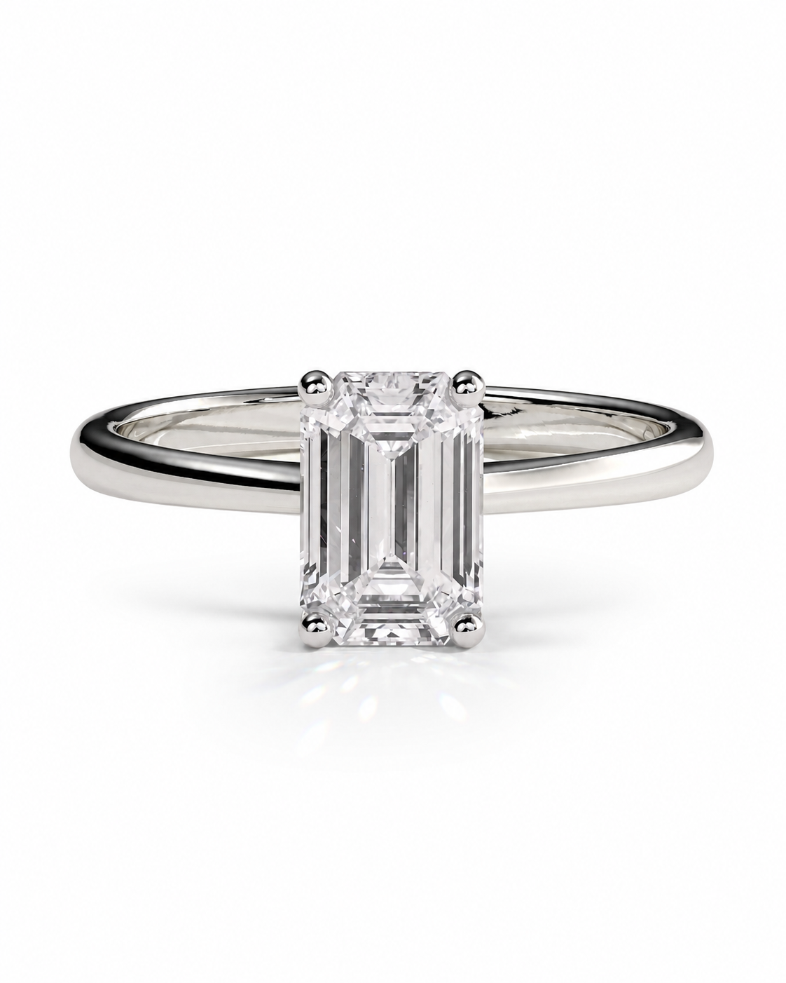 color_925_SIL,color_935_ARG,color_10K_WG, color_14K_WG &&An emerald-cut diamond engagement ring with a polished silver-colored band, shown on a clean white background with a soft reflection.