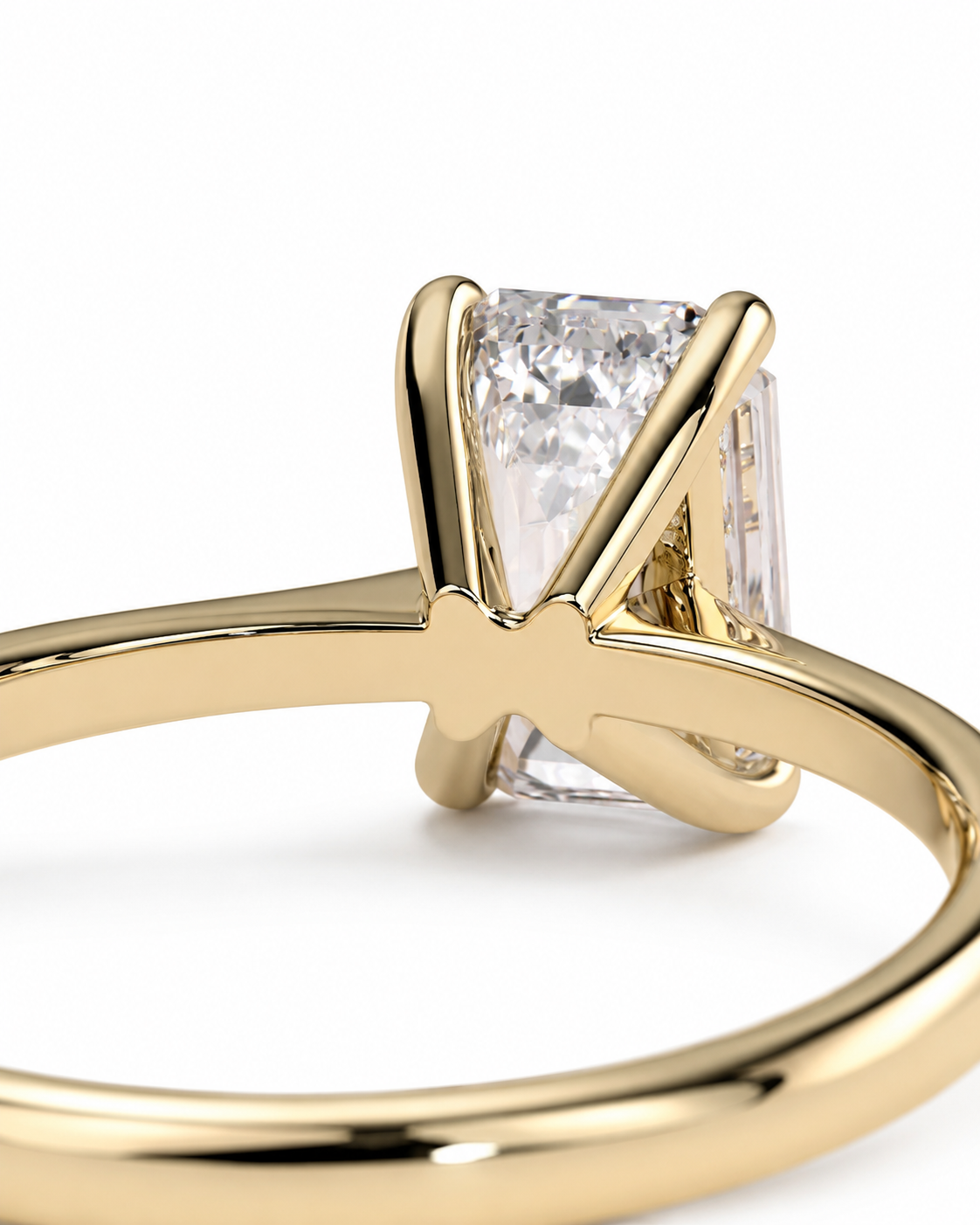 color_10K_YG, color_14K_YG &&A close-up shot of a yellow gold ring featuring a rectangular clear gemstone in a prong setting, shown against a clean white background.