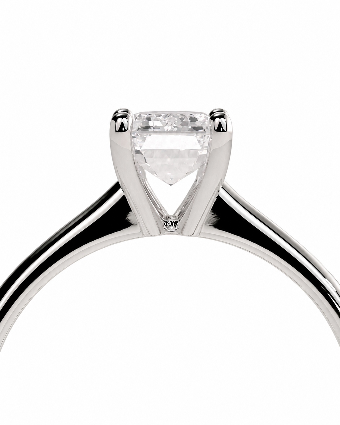 color_925_SIL,color_935_ARG,color_10K_WG, color_14K_WG &&A close-up studio shot of a solitaire engagement ring featuring a heart-shaped clear gemstone in a four-prong setting on a polished silver-colored band, set against a plain white background.
