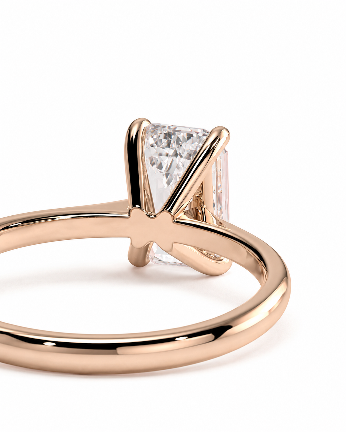 color_10K_RG, color_14K_RG &&A close-up shot of a rose gold ring featuring a rectangular clear gemstone in a four-prong setting, shown against a plain white background.
