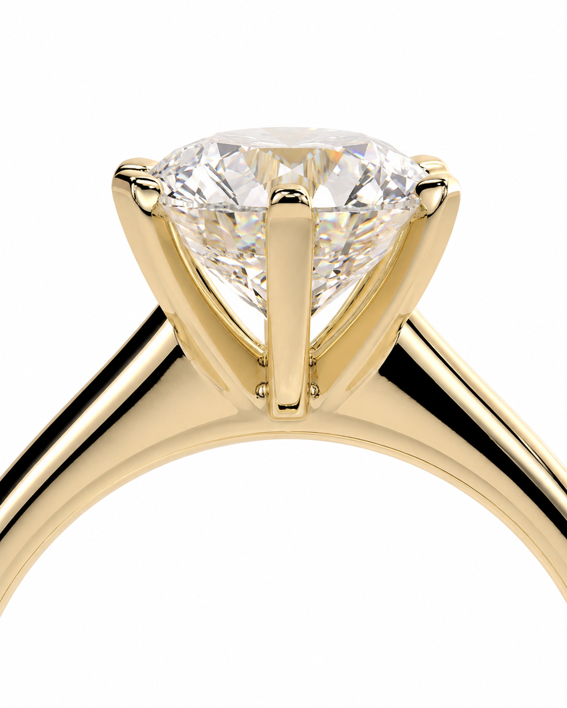 color_10K_YG, color_14K_YG &&A close-up of a yellow gold solitaire engagement ring featuring a round brilliant-cut diamond in a four-prong setting, shown against a solid white background.