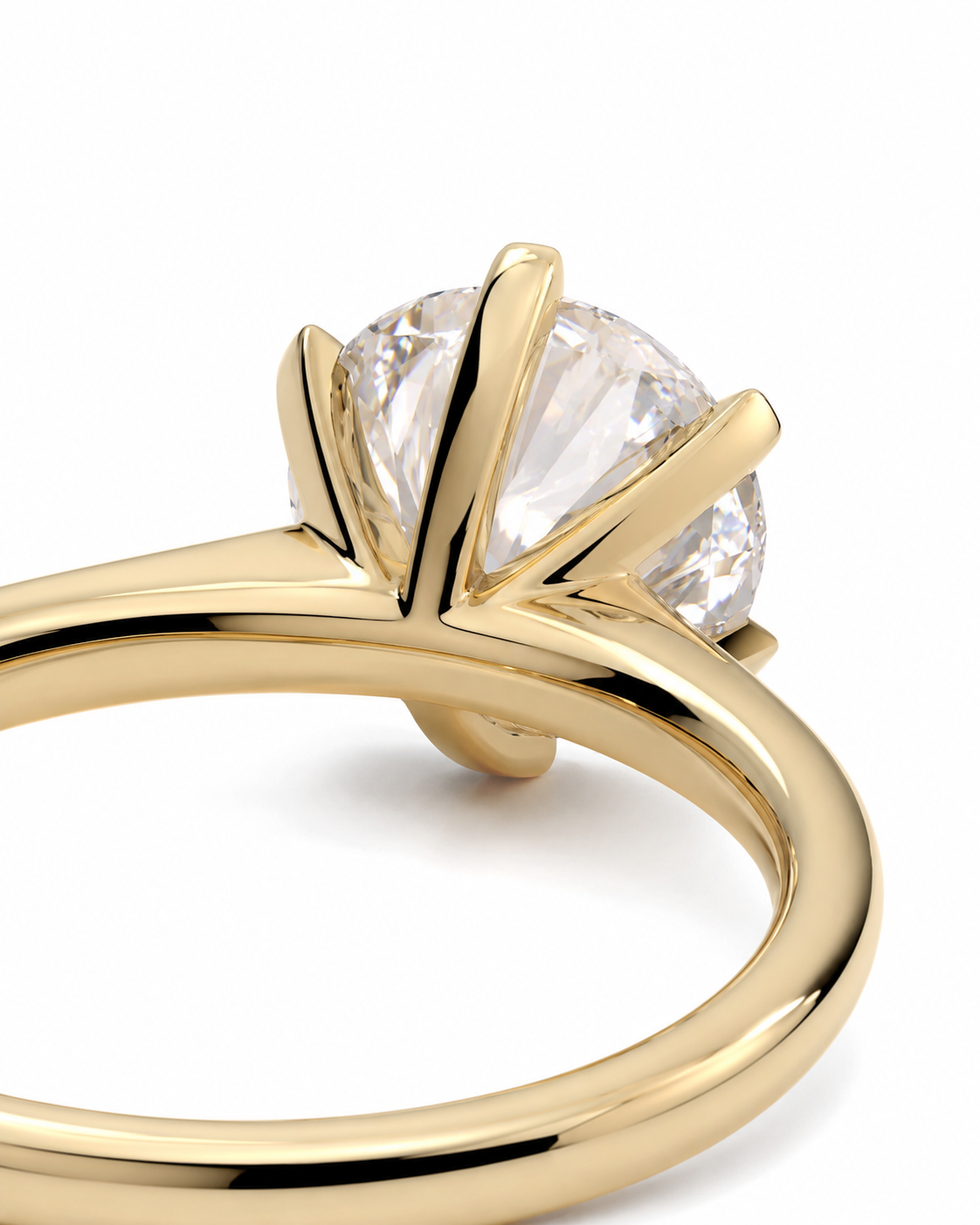 color_10K_YG, color_14K_YG &&A close-up of a yellow gold solitaire engagement ring featuring a round brilliant-cut clear gemstone in a prong setting, shown on a clean white background.