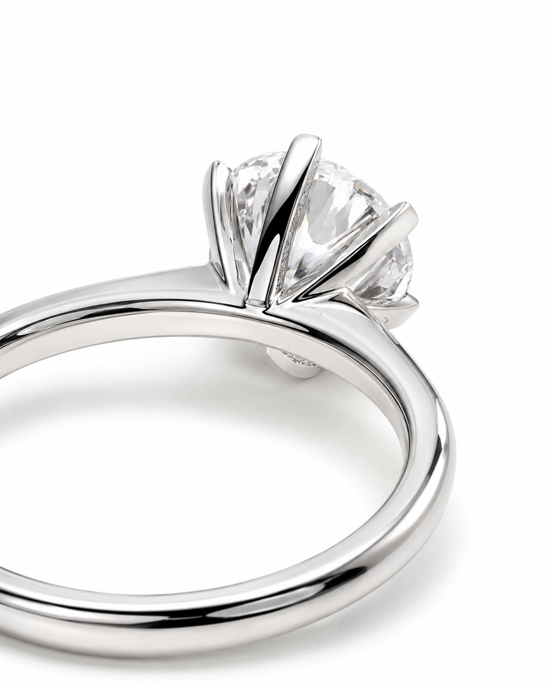 color_925_SIL,color_935_ARG,color_10K_WG, color_14K_WG &&A close-up studio shot of a silver-toned solitaire ring with a clear round gemstone in a prong setting, shown on a white background.