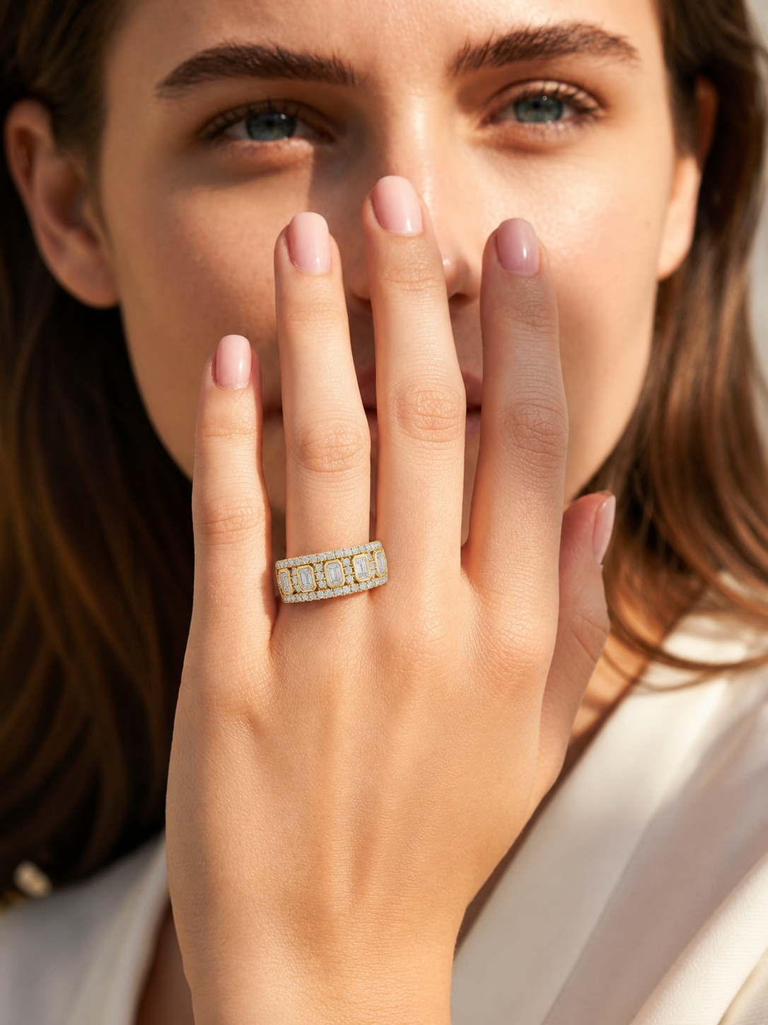 color_10K_YG, color_14K_YG &&	
Close-up of a multi-stone moissanite wedding band with brilliant round halo accents.